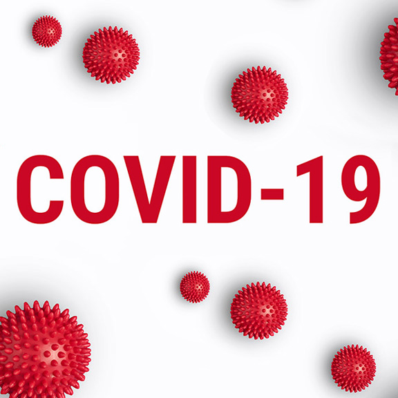 Rote Massagebälle die wie Viren aussehen um den Schriftzug COVID-19