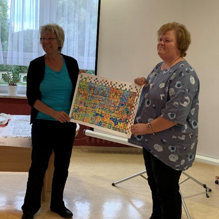 Frau Scheffler von con!flex überreicht feierlich den Kunstdruck für die erfolgreiche Qualitätstestierung an Frau Luther